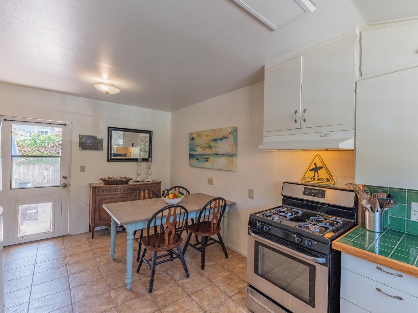 146 Hainline Road Aptos, CA 95003 - Photo 10 of 45 a kitchen with stainless steel appliances a stove a table and chairs in it