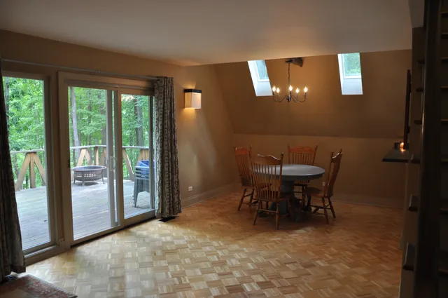 a view of a dining room with furniture and chandelier