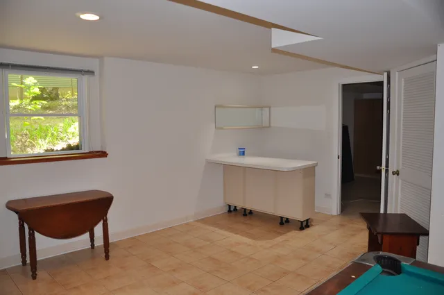 a room with a window and a chair