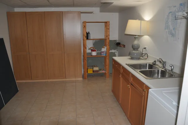 a kitchen with a sink and cabinets