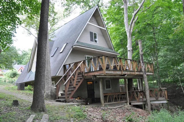 a front view of house with deck and outdoor seating