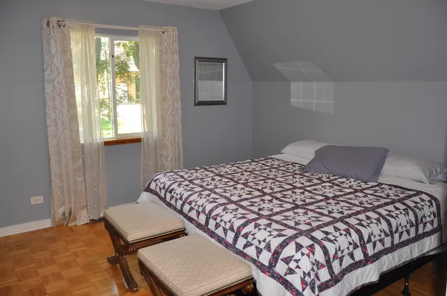 a bedroom with a bed and window