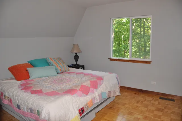 a bedroom with a bed and window