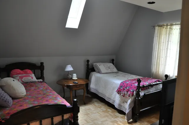 a bedroom with a bed and window