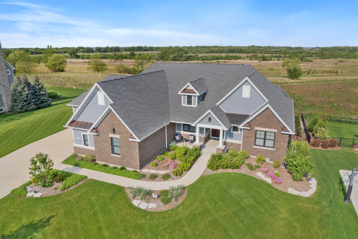 1812 Hunters Ridge Lane Sugar Grove, IL 60554 - Photo 1 of 45 a front view of a house with a garden
