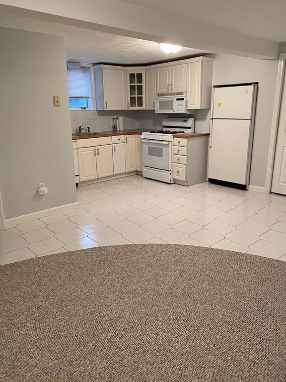 1 Salem Street, Unit B1 Wakefield, MA 01880 - Photo 9 of 12 a kitchen with refrigerator and microwave