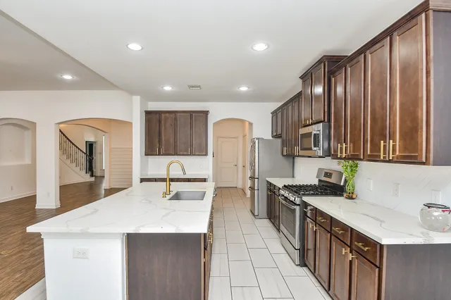 a view of a kitchen with wooden floor and a sink