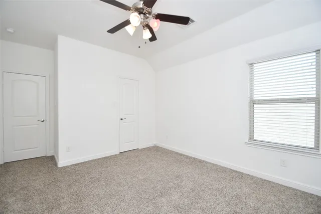 a bathroom with a granite countertop sink a toilet and a mirror