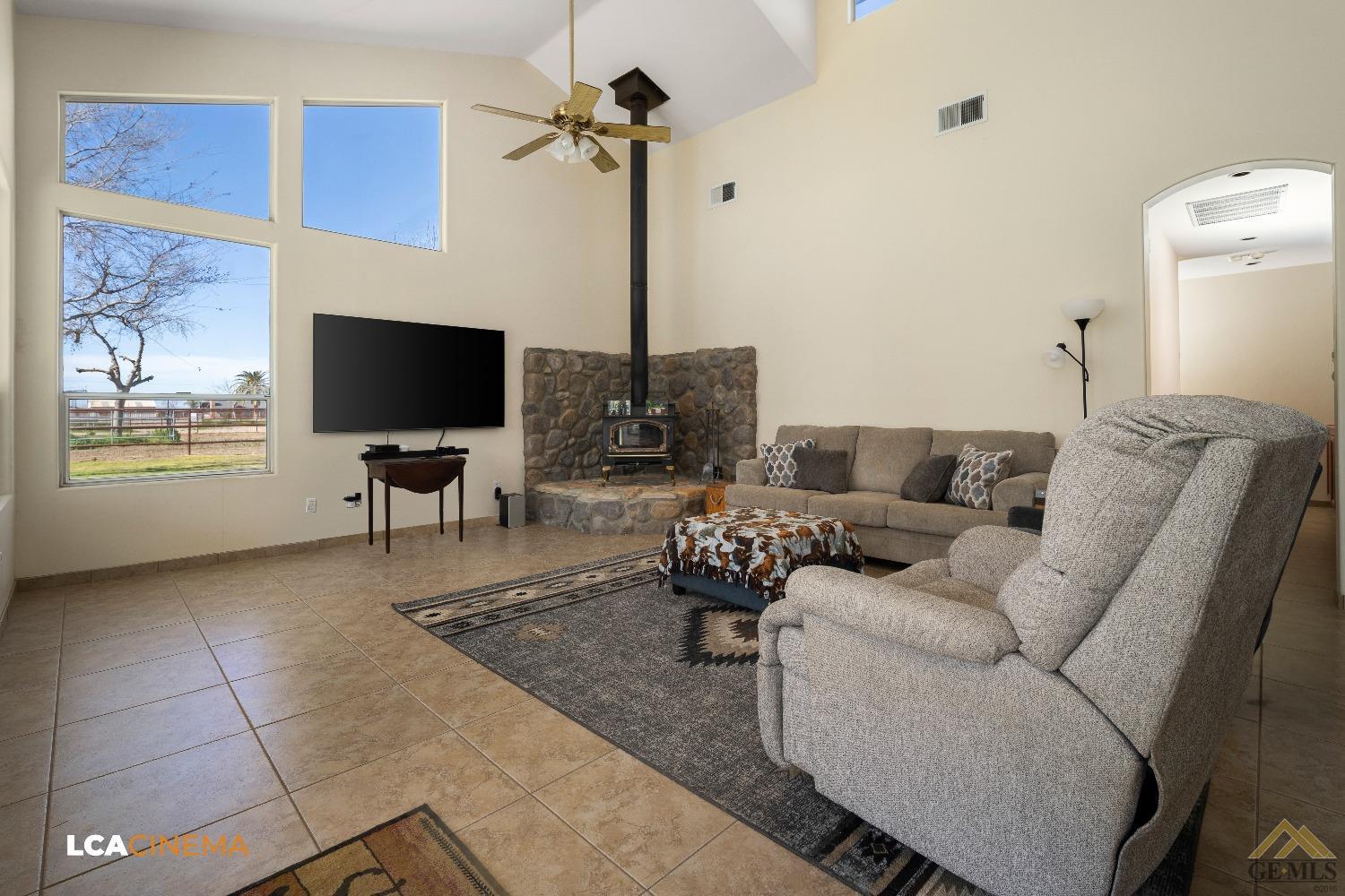 Undisclosed Address Bakersfield, CA 93314 - Photo 11 of 33 a living room with furniture and a flat screen tv