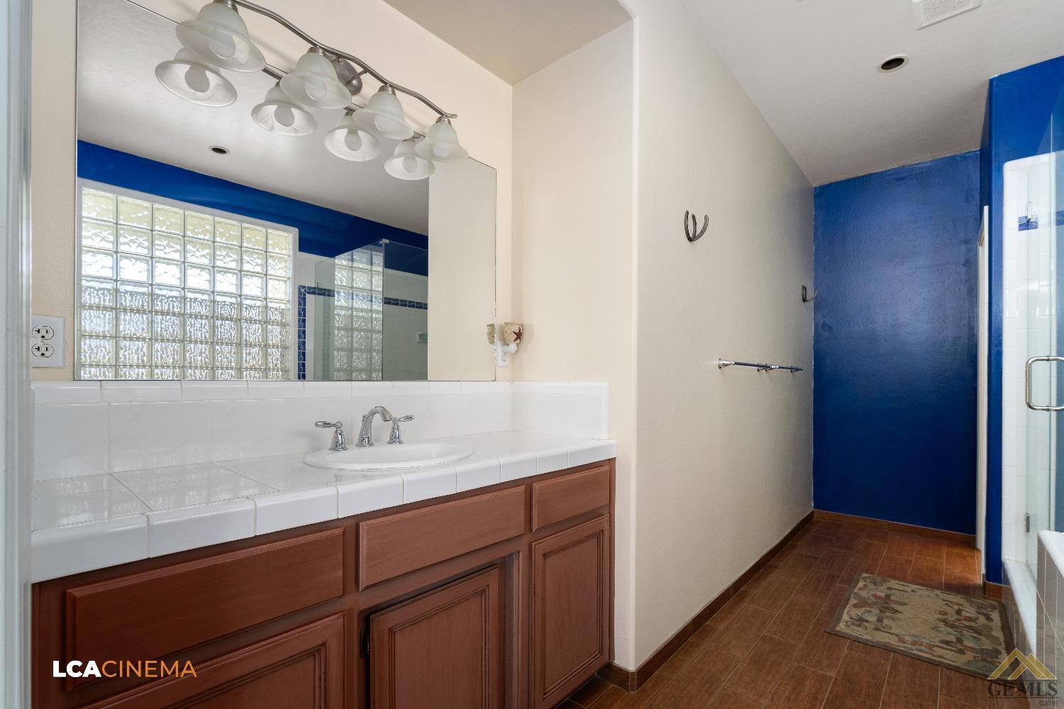 Undisclosed Address Bakersfield, CA 93314 - Photo 23 of 33 a bathroom with a sink and a mirror
