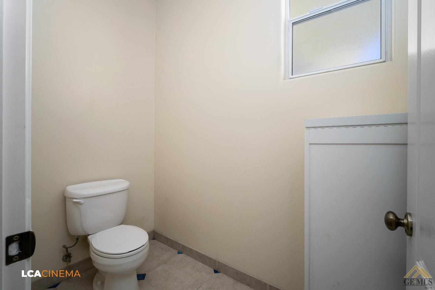 Undisclosed Address Bakersfield, CA 93314 - Photo 25 of 33 a white toilet sitting next to a small bathroom