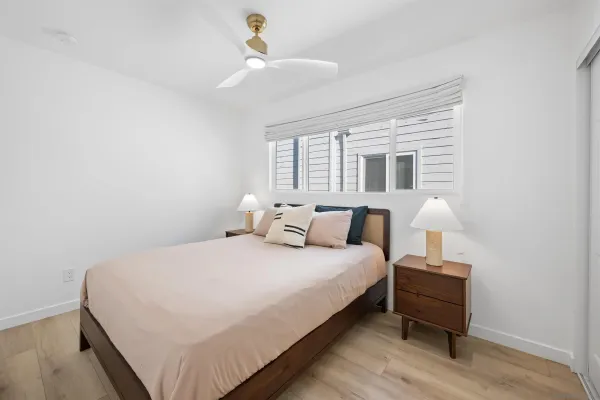 a bedroom with a bed and a lamp on table