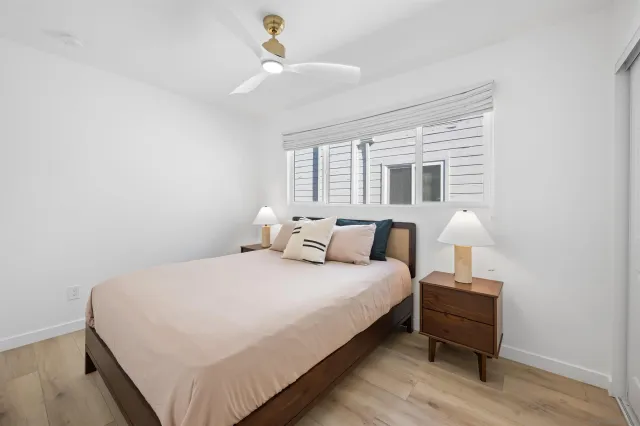 a bedroom with a bed and a lamp on table