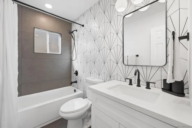 a bathroom with a sink a toilet and a bathtub