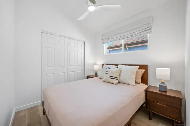 a bedroom with a bed and a night stand