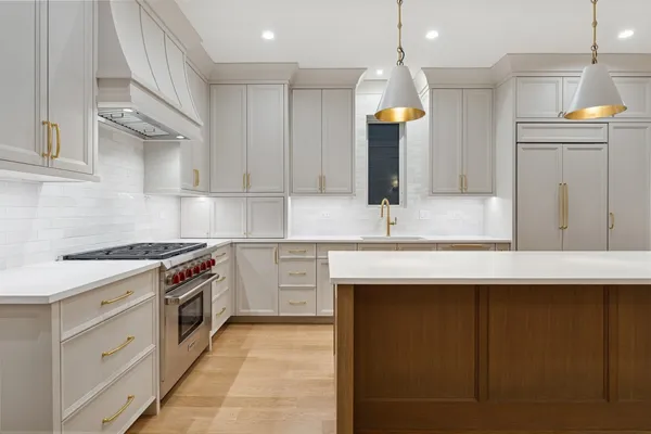 a kitchen with cabinets and stove