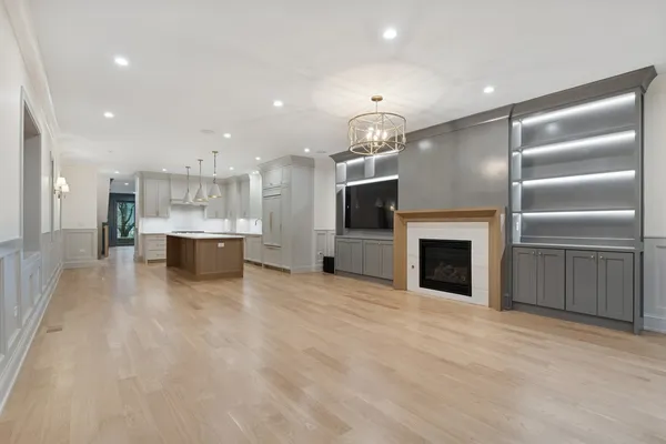 a view of kitchen with kitchen island a sink stainless steel appliances and cabinets