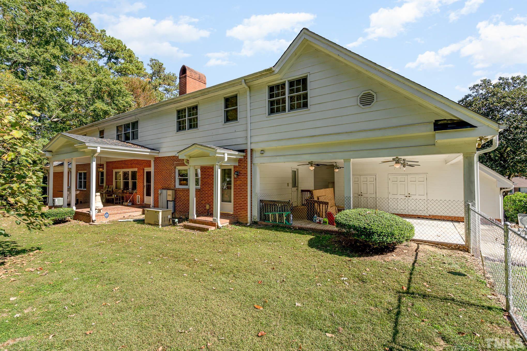 5601 Castlebrook Drive Raleigh, NC 27604 - Photo 32 of 34 a front view of a house with a yard and seating space