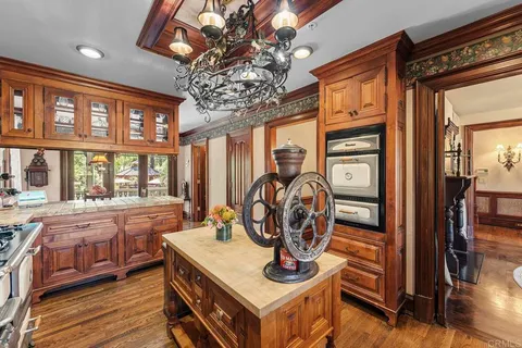 a dining room with furniture window and wooden floor