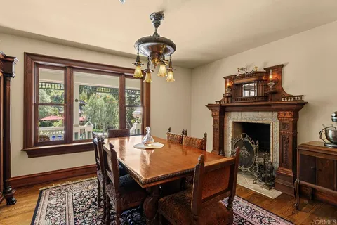 a living room with furniture a table and kitchen view