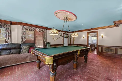 a bedroom with a bed and a flat tv screen on dresser