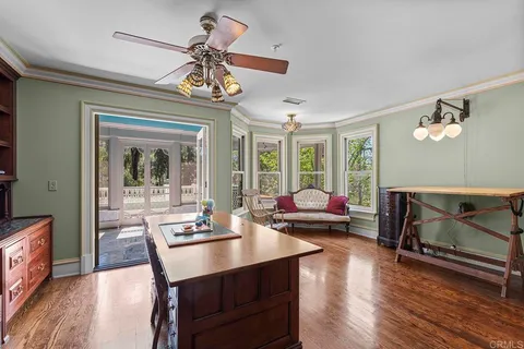 a living room with furniture and a dining table