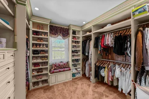 a view of a patio with a table and chairs under an umbrella
