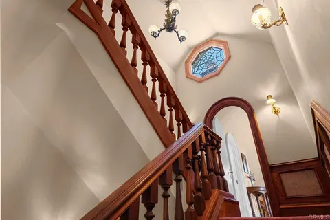 a view of a house with pool and chairs