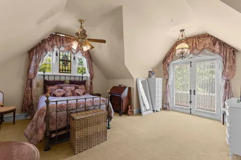 an aerial view of a house with a yard and lake view