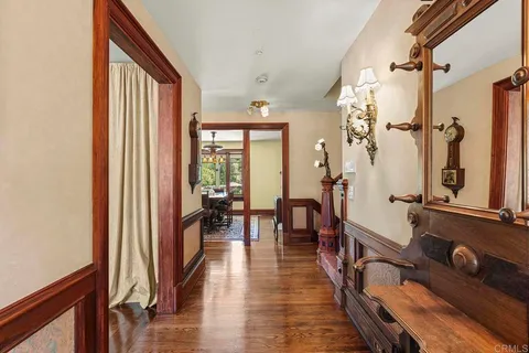 a view of a kitchen with granite countertop a sink a stove and wooden cabinets