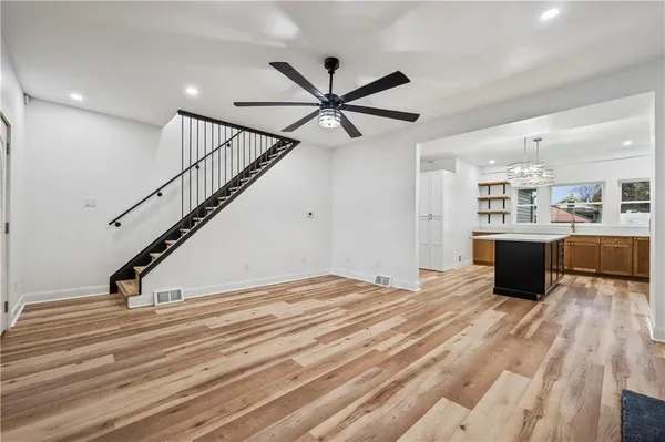 a view of kitchen and hall with wooden floor