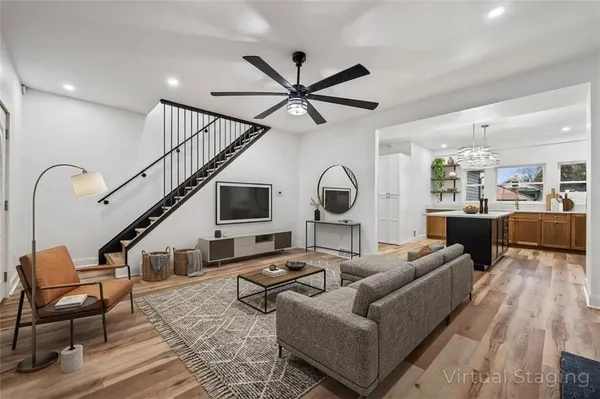 a living room with furniture or kitchen view and a wooden floor