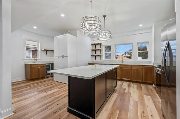 a kitchen with stainless steel appliances granite countertop a sink a stove top oven a counter space and cabinets