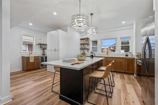 a kitchen with stainless steel appliances a table chairs and a chandelier