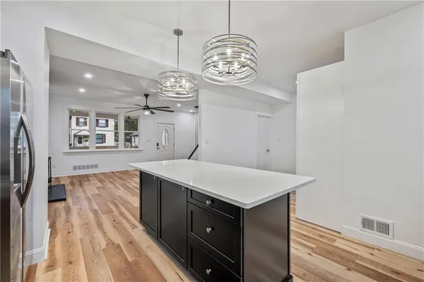 a view of a kitchen wooden cabinets and wooden floor