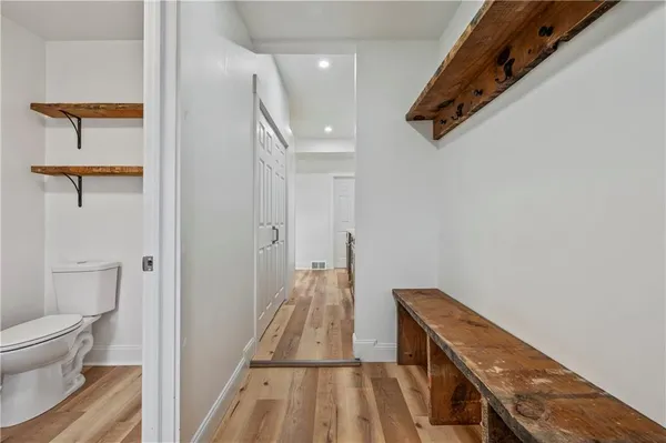 a view of a hallway with wooden floor and staircase