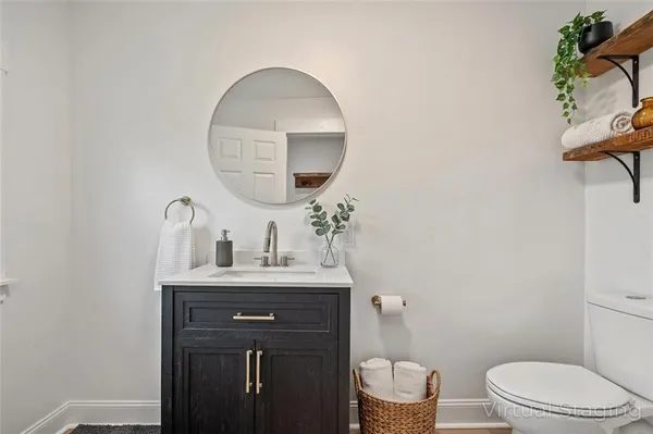 a bathroom with a toilet a sink and mirror