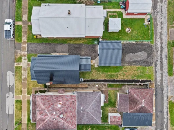 an aerial view of a house with a yard