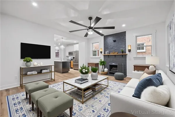 a living room with furniture a fireplace and a flat screen tv