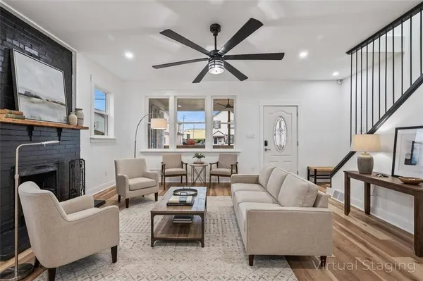 a living room with fireplace furniture and a flat screen tv