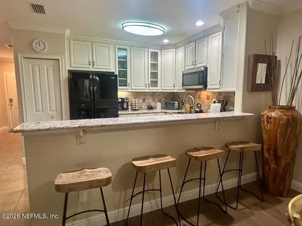 a spacious bedroom with a bed and a flat screen tv