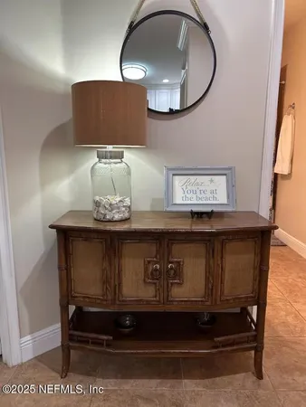 a kitchen with stainless steel appliances a dining table chairs refrigerator and sink