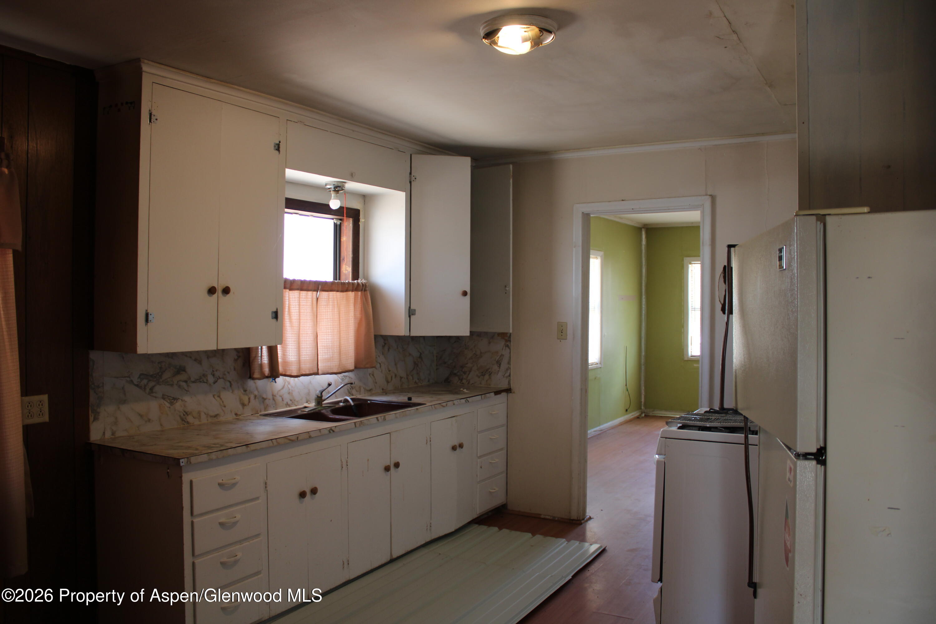 302 West Main Street Rangely, CO 81648 - Photo 4 of 11 a bathroom with a granite countertop sink and a mirror