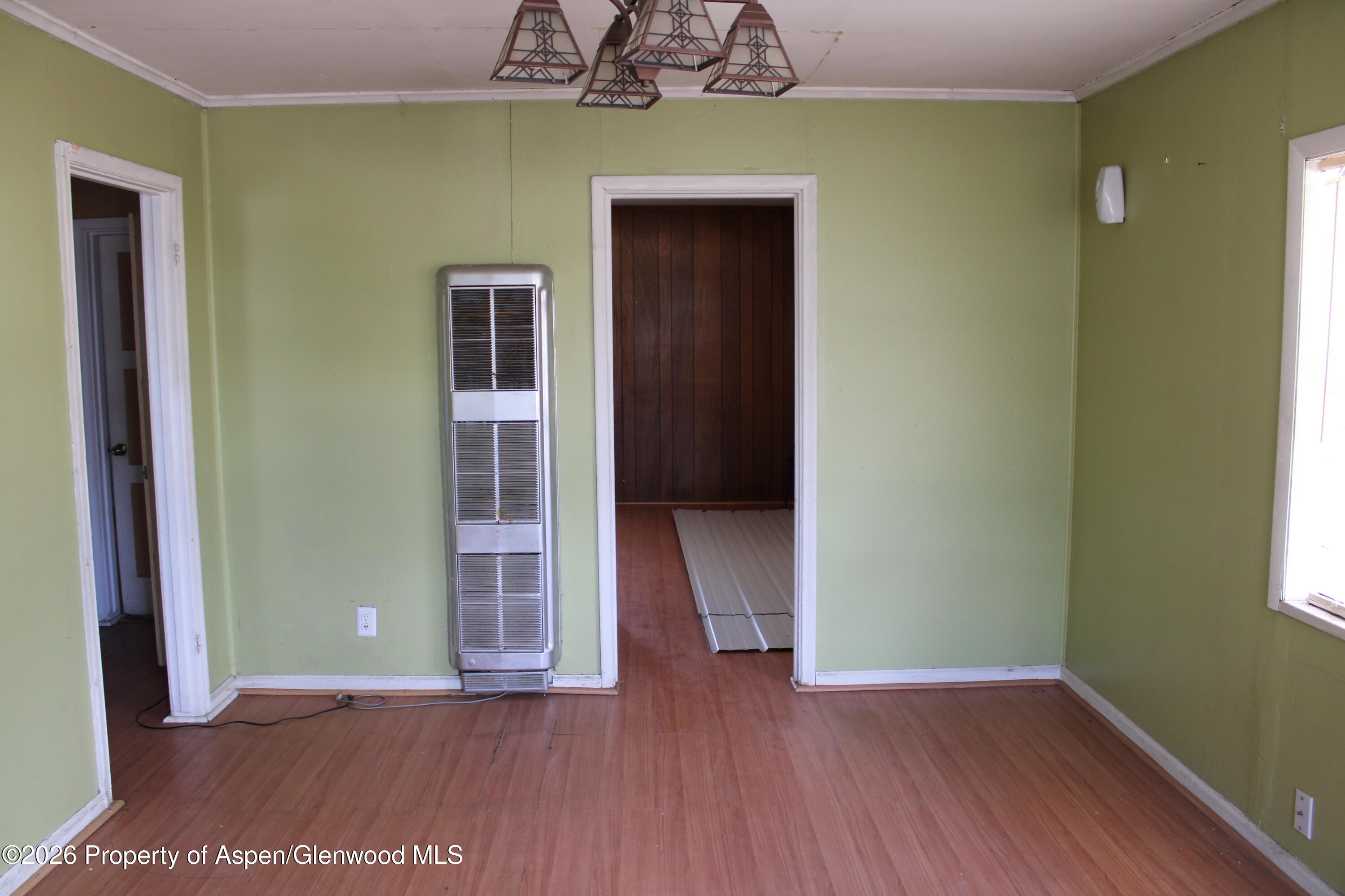 302 West Main Street Rangely, CO 81648 - Photo 6 of 11 an empty room with wooden floor and closet
