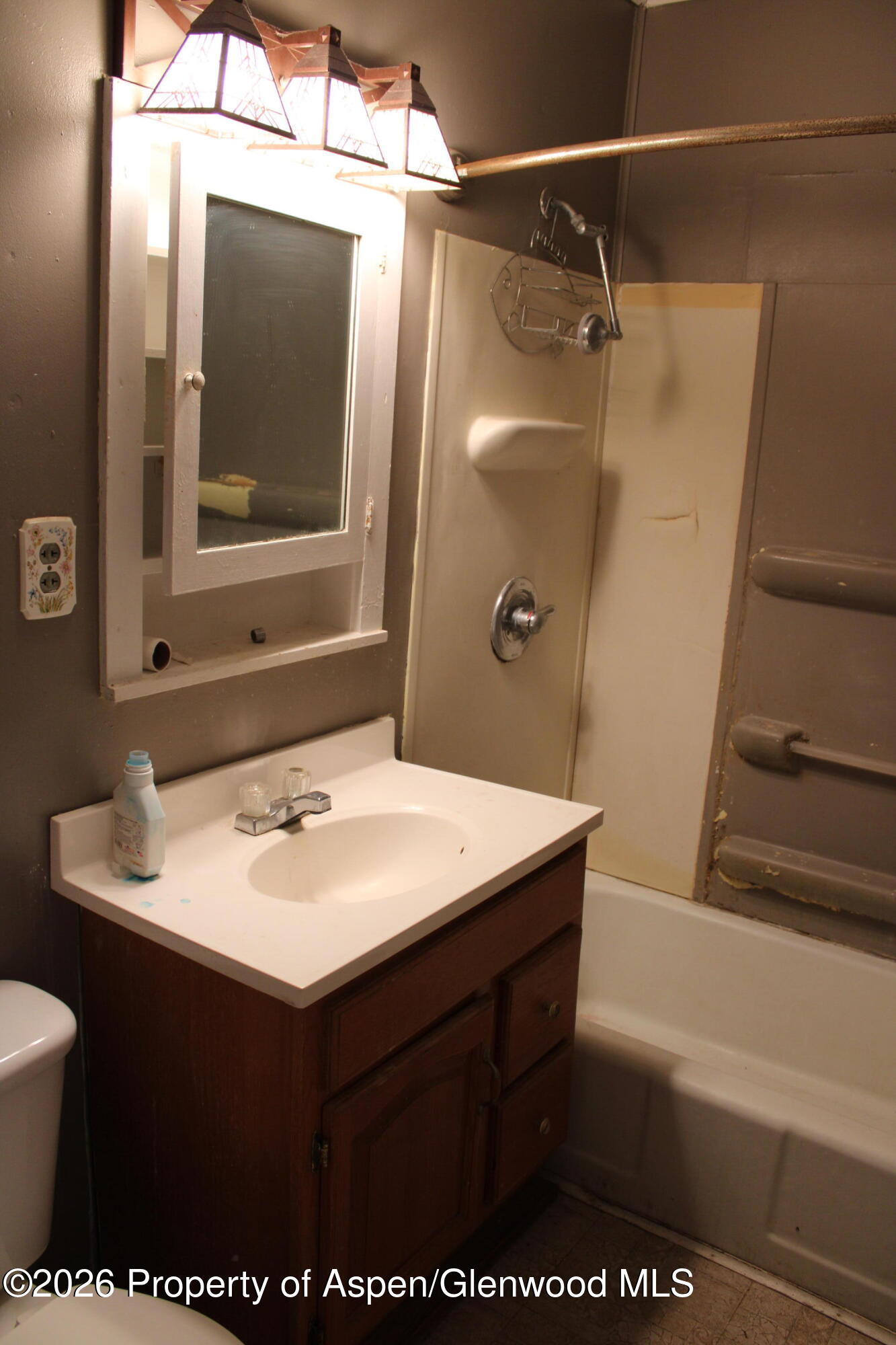 302 West Main Street Rangely, CO 81648 - Photo 7 of 11 a bathroom with a sink a mirror and a bathtub