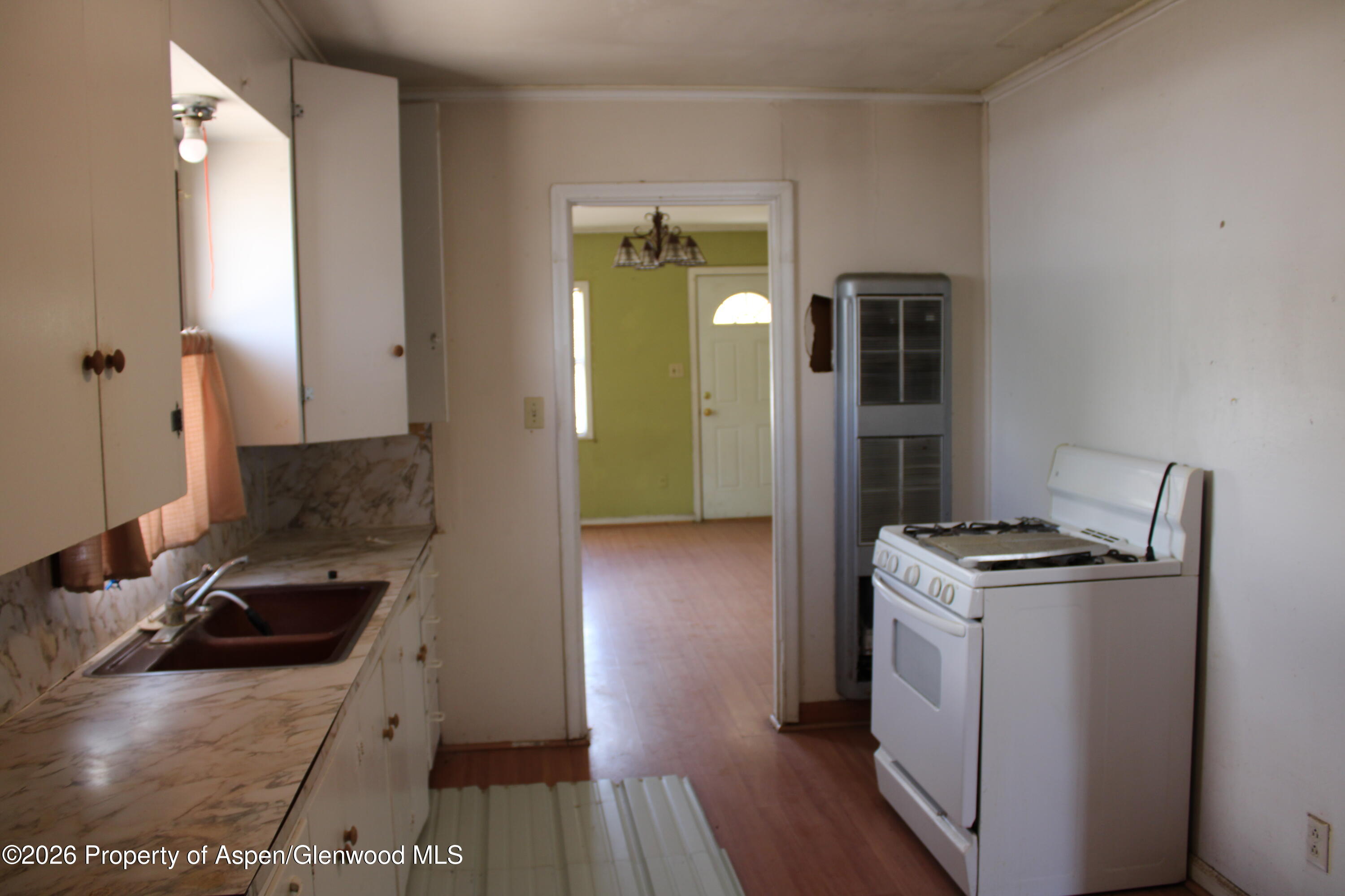 302 West Main Street Rangely, CO 81648 - Photo 10 of 11 a kitchen with a stove and a refrigerator