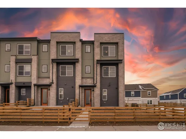 a front view of a residential apartment building with a yard