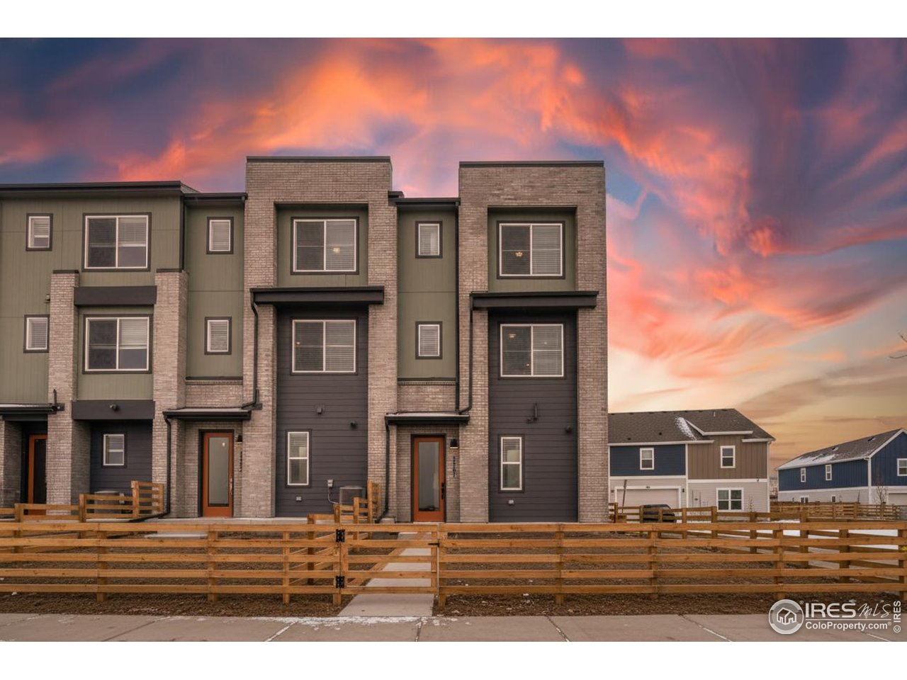 a front view of a residential apartment building with a yard