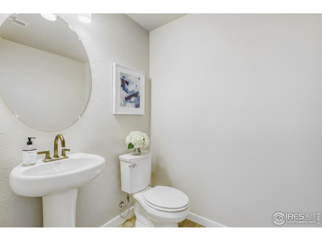 2367 East Suniga Road Fort Collins, CO 80524 - Photo 15 of 26 a bathroom with a sink mirror and toilet