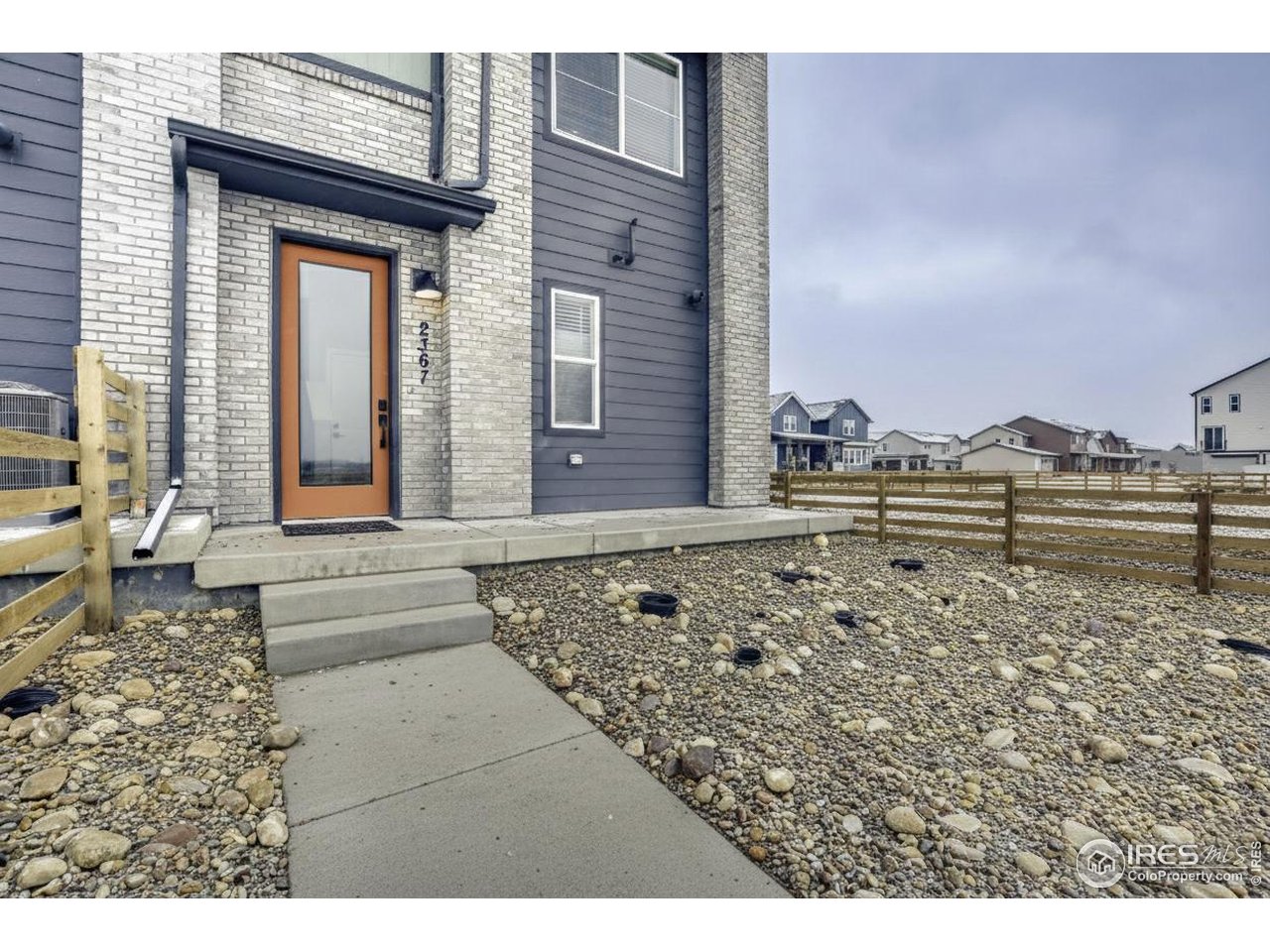 2367 East Suniga Road Fort Collins, CO 80524 - Photo 3 of 26 a view of a brick house with a yard